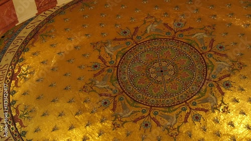 A detailed view of the golden mosaic ceiling in Notre-Dame de la Garde Basilica, Marseille, featuring religious symbols, floral patterns, and sacred iconography in shimmering gold leaf.