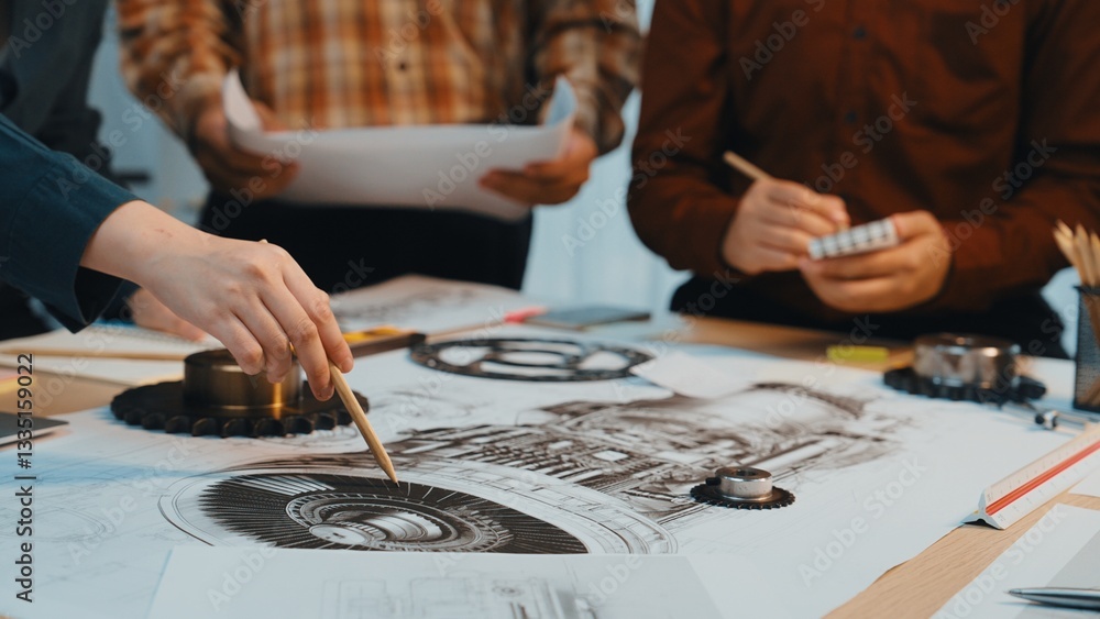 Fototapeta premium Engineers engage in a dynamic discussion over intricate technical drawings in a collaborative workspace, illustrating creativity and teamwork in project development. SACTR