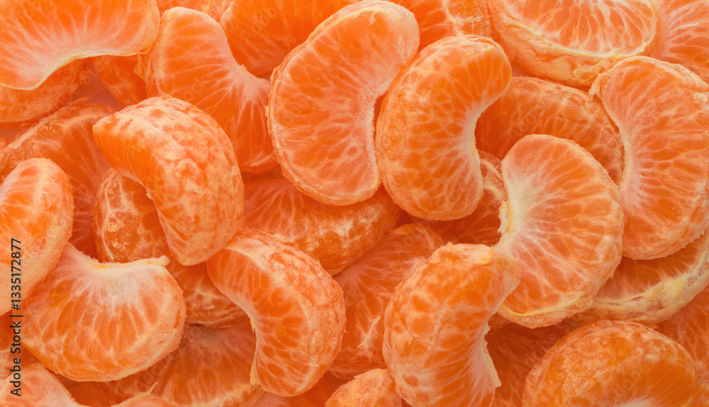 Slices of ripe tangerine background top view
