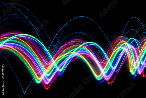 A long exposure photograph of colourful lights in swirl patterns of motion against a black background