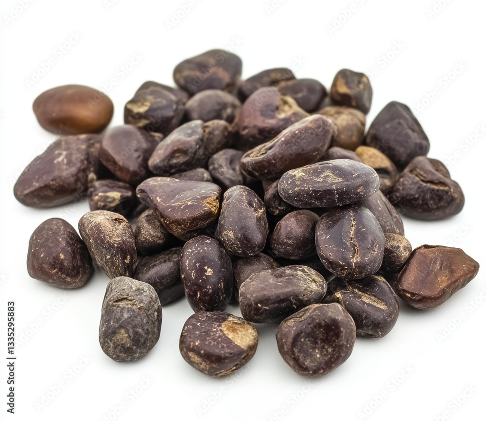Pile of dark brown seeds on white background Pile of dark brown seeds on white background