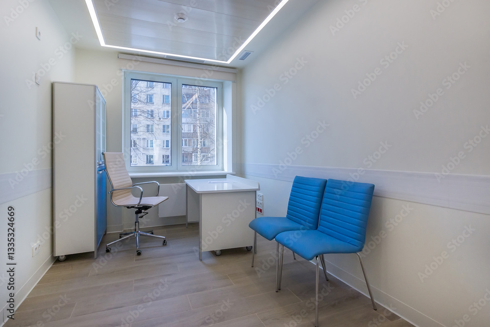 A doctor's office with cupboards, a table and chairs, in an outpatient clinic. A doctor's office with cupboards, a table and chairs, in an outpatient clinic.