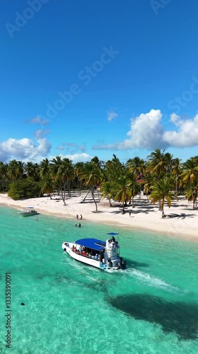 Drone view of Saona Island, turquoise waters, white sand, boats and a pure tropical paradise in the Dominican Republic.