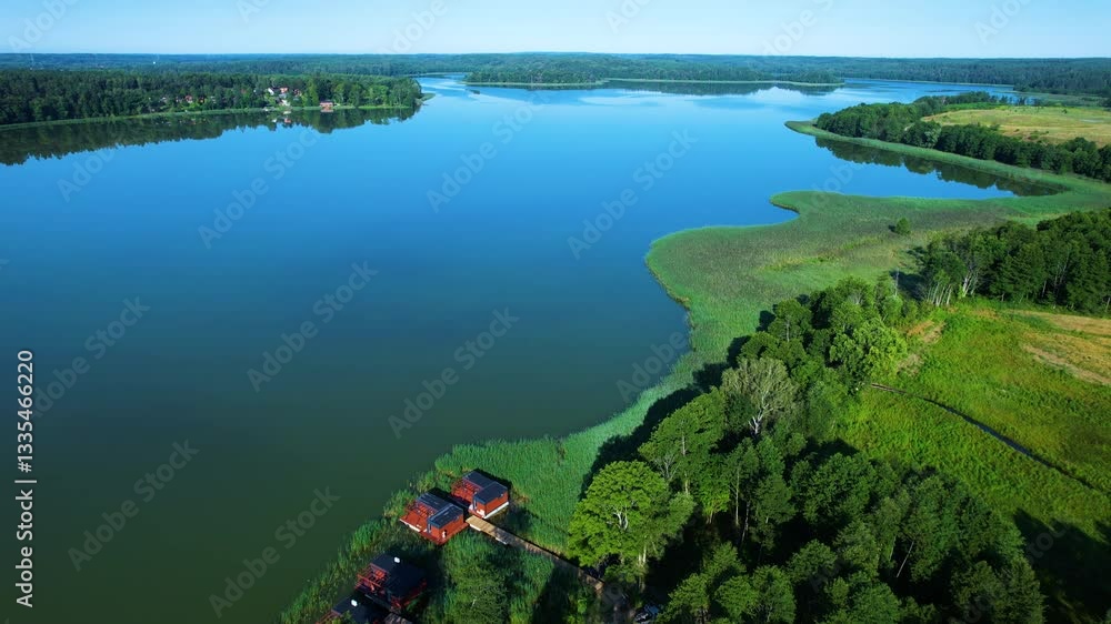 Majestic Aerial View of Calm Lake With Islands in Poland. Village Houses on Shore of Paradise Lake. Peaceful Reflected on Water. Spectacular Beautiful Lake Aerial View. Epic Amazing Nature Landscape. Majestic Aerial View of Calm Lake With Islands in Poland. Village Houses on Shore of Paradise Lake. Peaceful Reflected on Water. Spectacular Beautiful Lake Aerial View. Epic Amazing Nature Landscape.