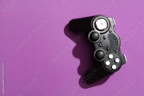 Modern game pad on purple b...