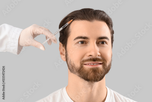 Young man receiving injecti...