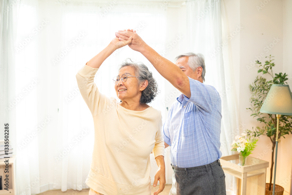 Fototapeta premium Happy Asian family senior couple enjoy and fun leisure activity lifestyle dancing together in living room. Healthy elderly husband and wife relaxing at home. Aged people mental healthcare concept.