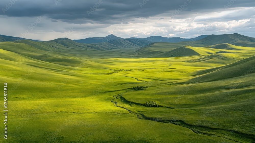 Naklejka premium Sunlit Green Valley Landscape Under a Dramatic Sky