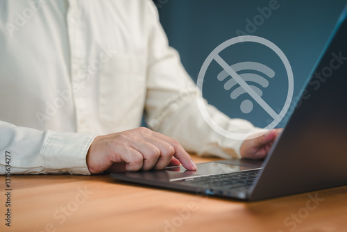 Quadro su tela Male person using a laptop computer to connect to wifi, representing internet connectivity issues, network failure, offline mode, or technology disruption