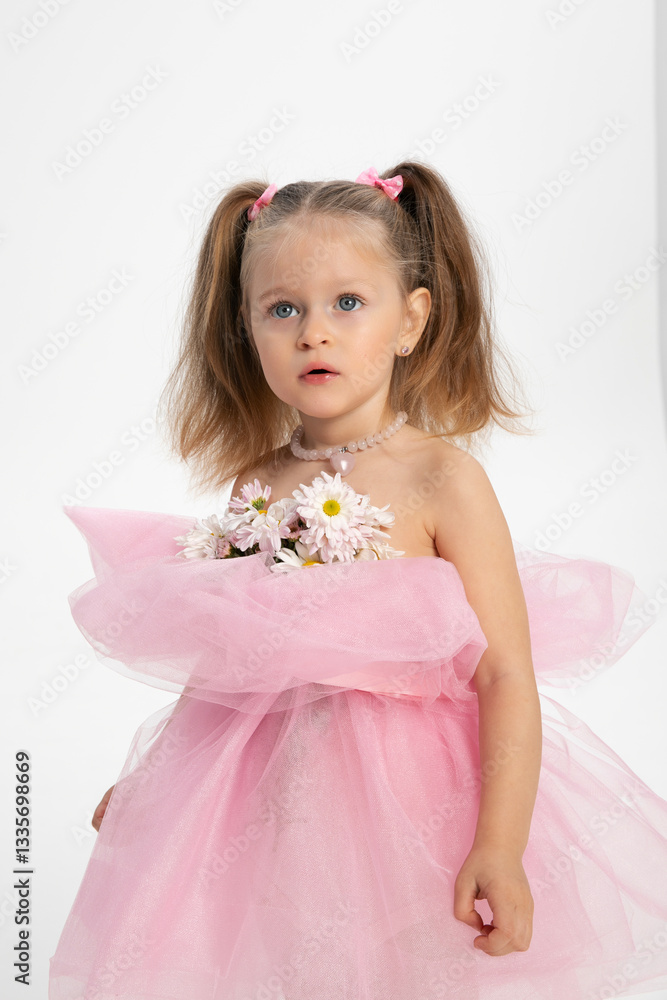 Closeup image of a pretty little girl in a pink dress with flowers, looking up, isolated white background. Closeup image of a pretty little girl in a pink dress with flowers, looking up, isolated white background.