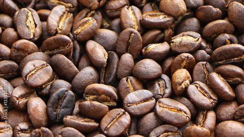 Background of fresh roasted coffee beans close up. Image for backdrops or recipes.