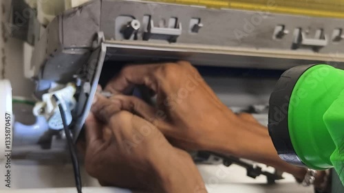 A technician repairs a wall mounted air conditioner and fixing HVAC systems