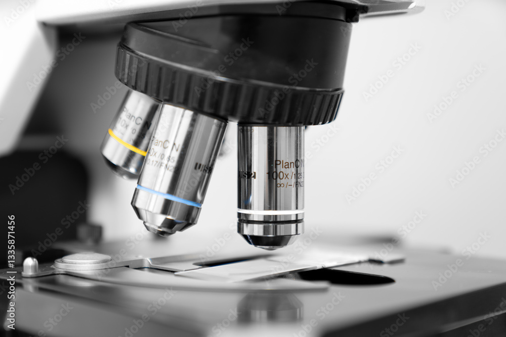 Close up of a high-precision laboratory microscope with 10x, 40x, and 100x objective lenses, used for scientific research, medical diagnostics, biotechnology, and microbiology analysis in a profession Close up of a high-precision laboratory microscope with 10x, 40x, and 100x objective lenses, used for scientific research, medical diagnostics, biotechnology, and microbiology analysis in a profession