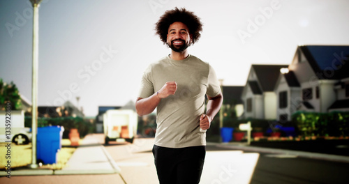 Athletic African American man jogging through the city