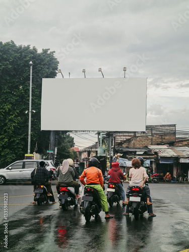 Blank big advertising billboard at Jakarta Street with motorcycle traffic foreground. Blank ads mockup.