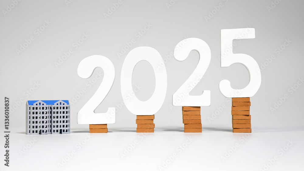 2025 real estate market forecast with house models and brick stacked