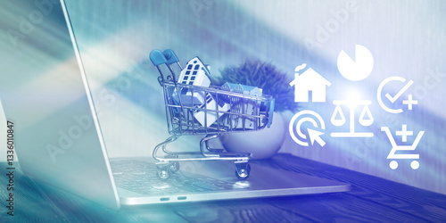 Mini shopping cart with house models on a laptop, symbolizing online real estate transactions, property investment, and digital housing market trends.