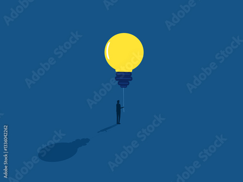 Businessman holding a balloon of knowledge light bulb