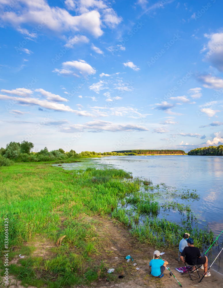 Man and a woman are fishing by a lake Man and a woman are fishing by a lake