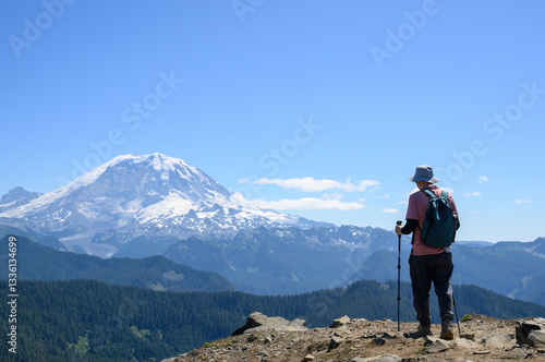Obraz na płótnie Man hiking Summit Lake trail. Mt Rainier in the distance. Mt Rainier National Park. Washington State. w salonie