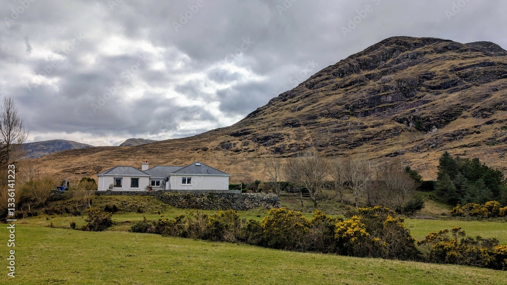 Beautiful landscape scenery, farmhouse by river Erriff surrounded by mountains near Aesleagh falls, county Mayo, Ireland, nature background