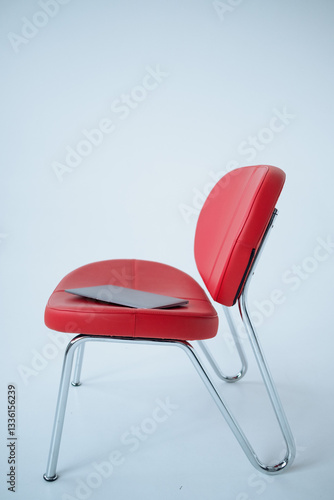 laptop on the red armchair