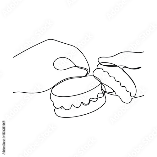 Oneline drawing of hands delicately handling macarons