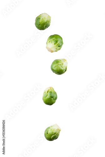 Fresh Brussels sprouts tumble gracefully in mid-air against a plain white background highlighting their vibrant green color and unique shape
