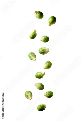 Fresh brussels sprouts falling in a vertical line against a bright white background showcasing their vibrant color and texture