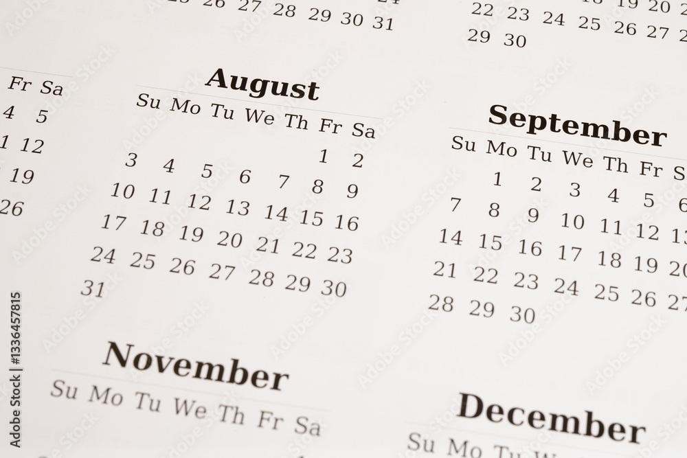 Fototapeta premium Close-up of a printed calendar displaying August, September, November, and December 