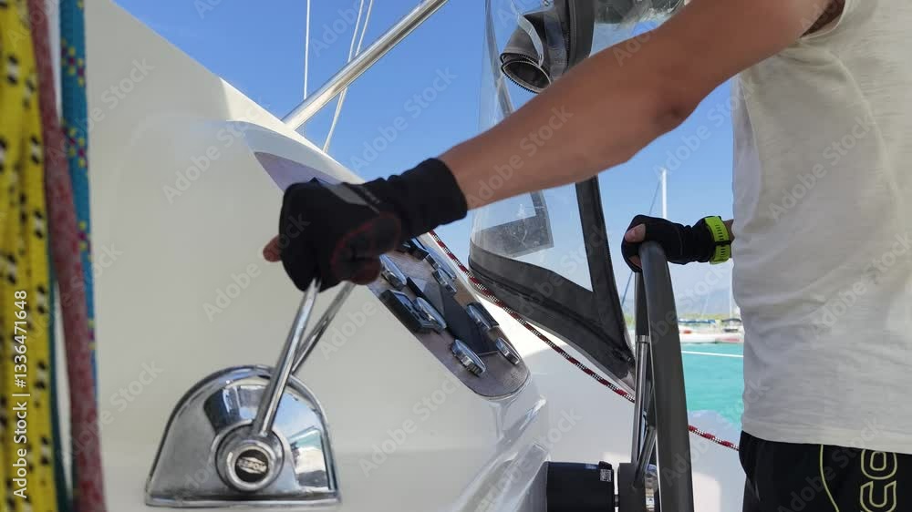 Young male captain in black gloves steering voyage boat Young male captain in black gloves steering voyage boat