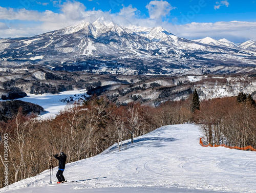 Obraz na płótnie Skier at top of ski slope in snow with spectacular mountain backdrop w salonie