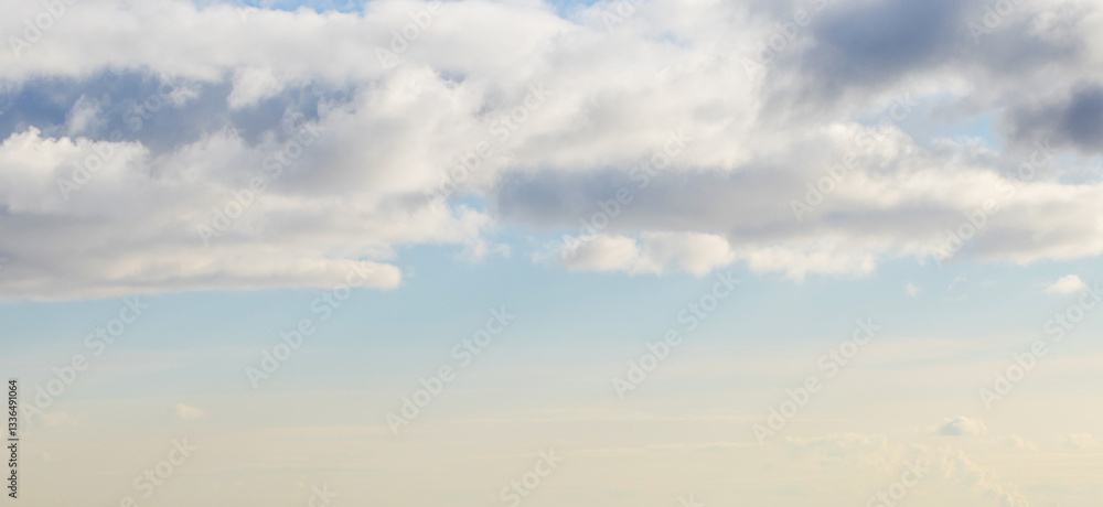 A peaceful view of a bright blue sky filled with fluffy white clouds A peaceful view of a bright blue sky filled with fluffy white clouds