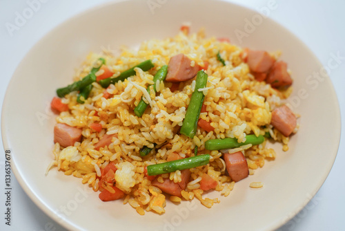 Obraz na płótnie Fried rice with egg, carrots and ham sausage. A plate of special fried rice. Staple food in China.. w salonie