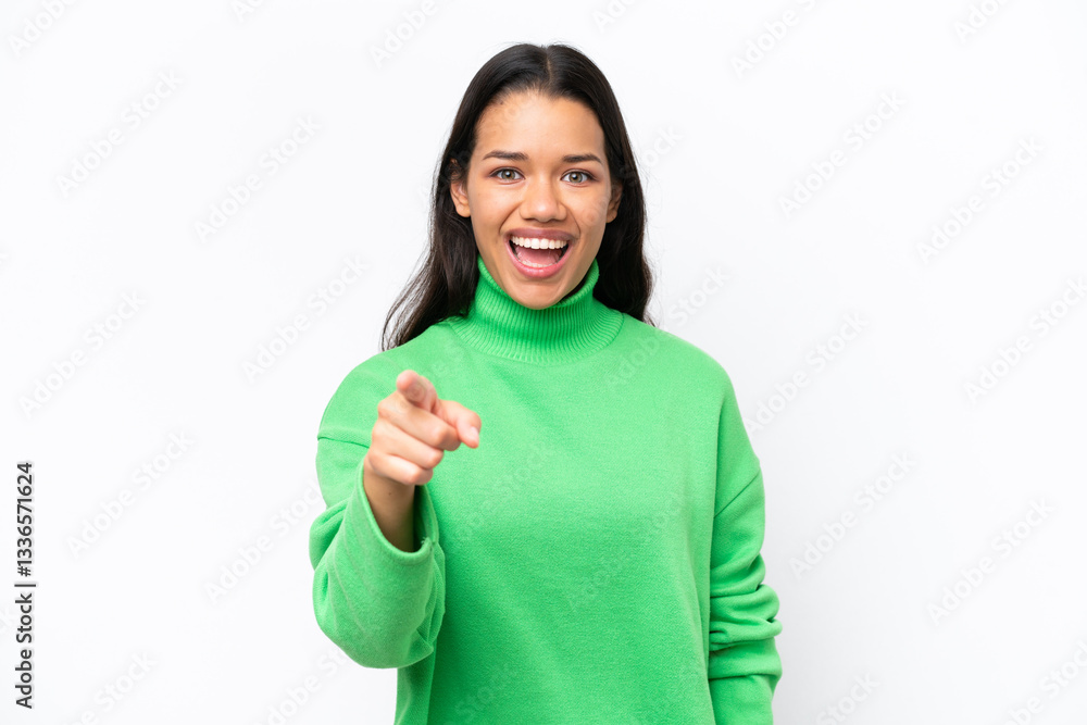 Young Colombian woman isolated on white background surprised and pointing front Young Colombian woman isolated on white background surprised and pointing front