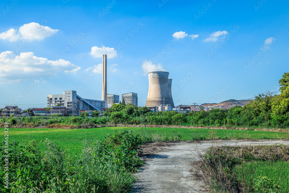 Power plant landscape with green field under blue sky Power plant landscape with green field under blue sky