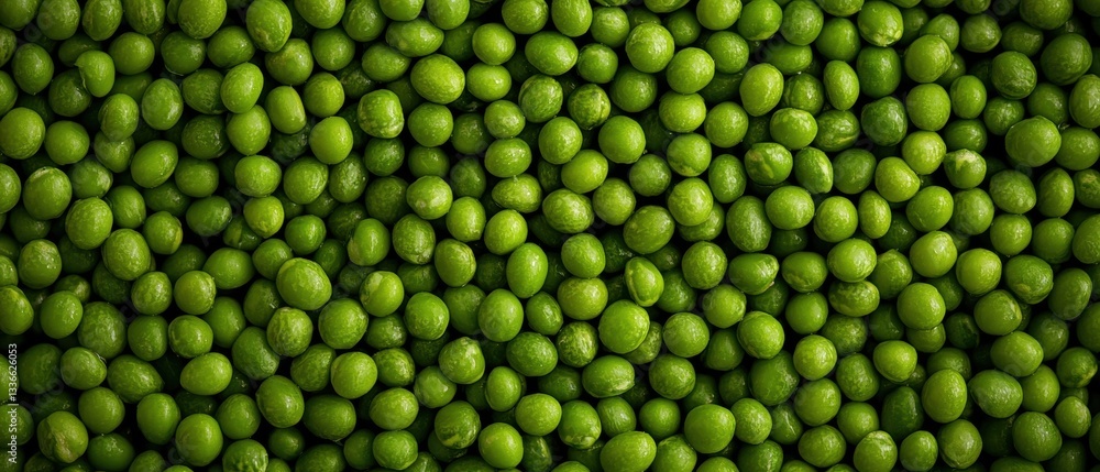 Close-up of a large number of small, round, green peas. the peas are arranged in a uniform pattern, with each pea slightly overlapping the one below it. Close-up of a large number of small, round, green peas. the peas are arranged in a uniform pattern, with each pea slightly overlapping the one below it.