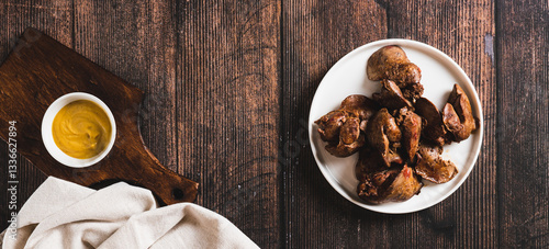 Obraz na płótnie Homemade stewed chicken liver on a plate on the table top view web banner w salonie