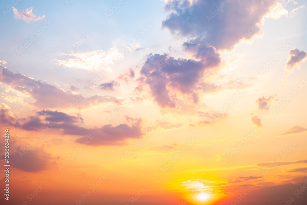 Obraz premium Sky,sunset, beautiful , luxury soft gradient orange gold clouds and sunlight on the blue sky perfect for the background, Sunrise on morning or evening in winter warm time ,Twilight summer,silhouette