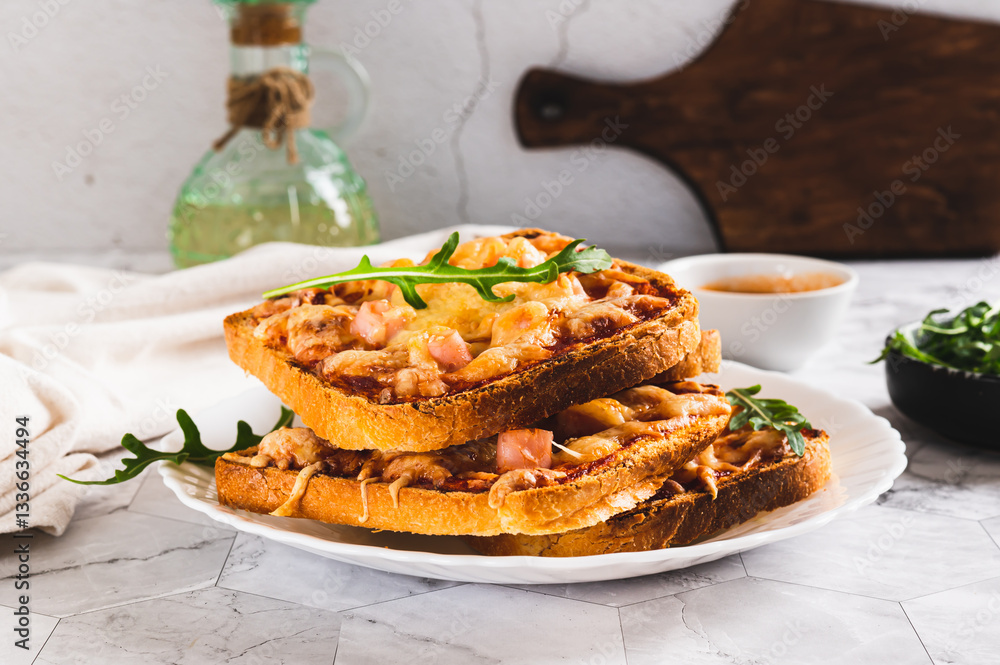 Baked toasts with bacon, cheese and tomato sauce on a plate on the table
