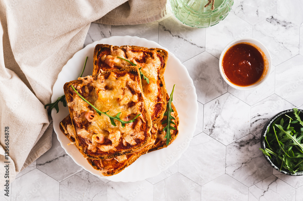 Baked toasts with bacon, cheese and tomato sauce on a plate on the table top view