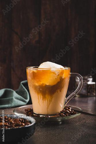 Delicious sweet affogato coffee with creamy ice cream in a cup on the table vertical view