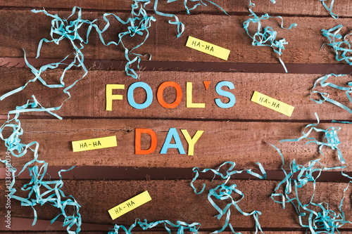Obraz na płótnie April Fools Day made of colored letters, funny notes and paper on wooden background w salonie