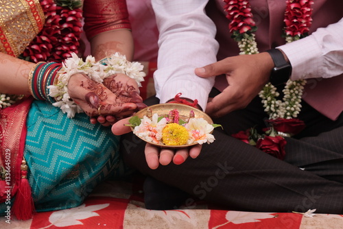 A men and women with Flowers in Hand Worshiping God, Indian Wedding Ceremony Ganesh Puja, Hindu Wedding Ritual Background photo