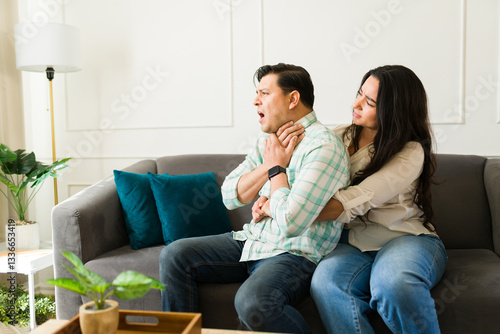 Canvas Print Woman performing heimlich maneuver on choking partner during urgent health crisi
