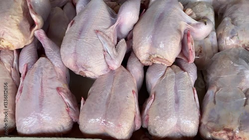 Chicken meat is sold in rows at the traditional market.