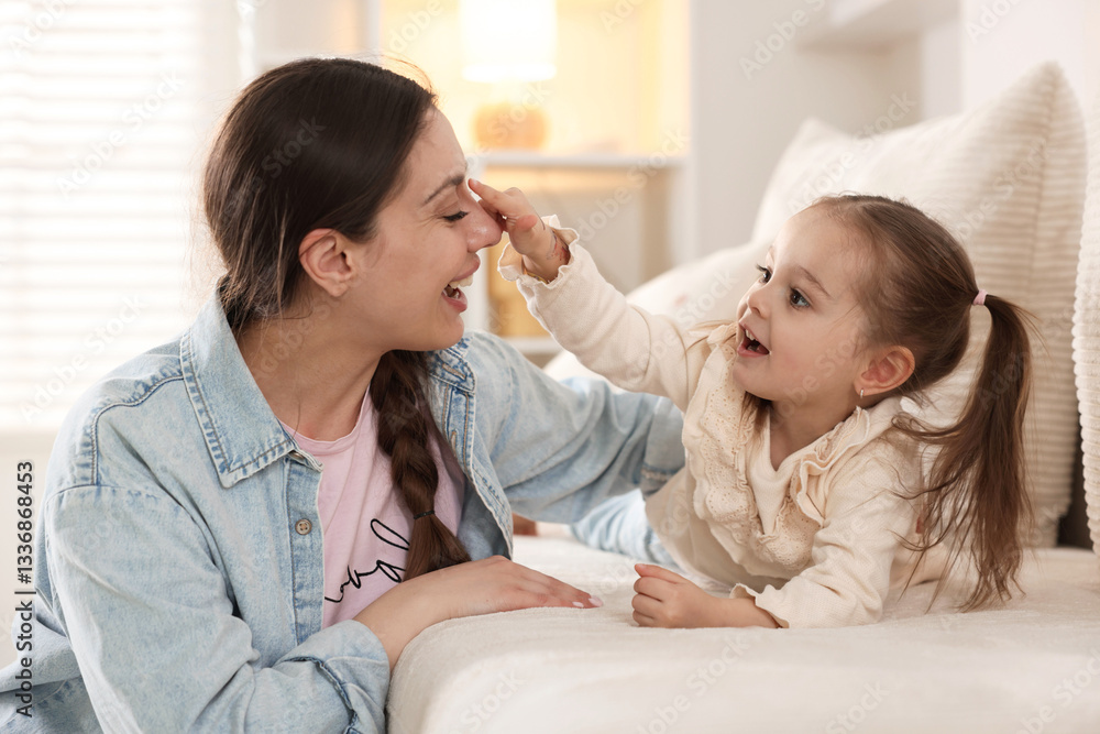 Happy mother with her cute daughter spending time together at home Happy mother with her cute daughter spending time together at home