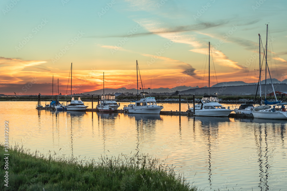 Racing sailing boats docked at Vancouver harbor. Marina With Docked Yachts during beautiful sunset Racing sailing boats docked at Vancouver harbor. Marina With Docked Yachts during beautiful sunset