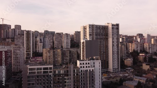 Drone view of a dense residential district in the city of Tbilisi, Georgia. Golden hour view of new and old architecture.
