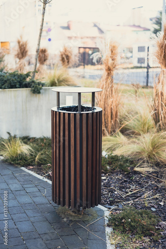 Wooden Public trash can on a city street filled with garbage. Garbage bin in park with blurred background